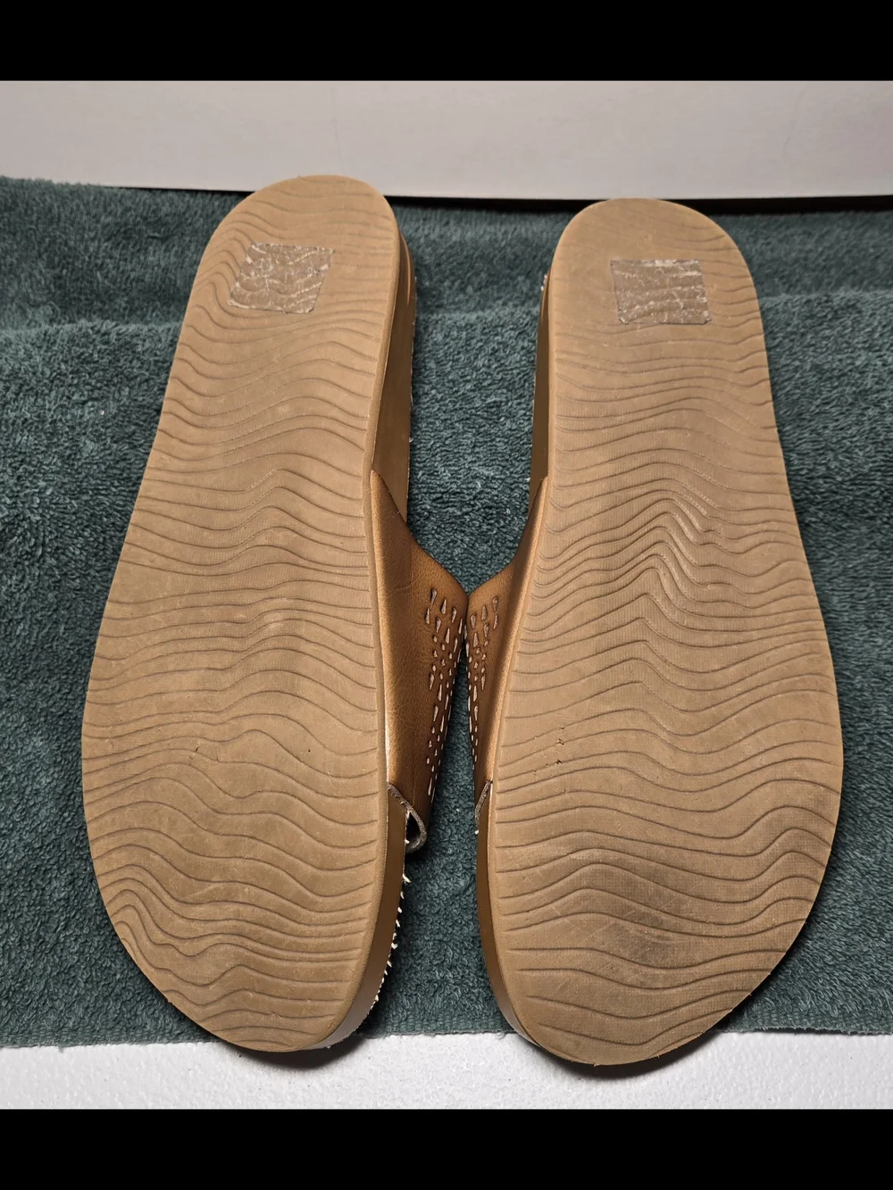 Reef women's comfort slide sandals featuring a soft cork footbed and perforated